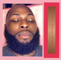 a man with a beard and a pink background